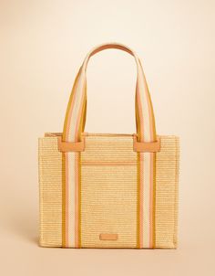 The Charlie Tote: made with soft faux straw, striped in bold webbing and trimmed in top grain Napa leather. With natural colors made to seamlessly work into your everyday style and an easy-to-reach back pocket, this tote will be your most-loved accessory. Baby Bubble Romper, Bonnet Cap, Spartina 449, Zip Tote, Bubble Romper, Hair Accessories Jewelry, Garment Bags, Womens Purses, Natural Colors