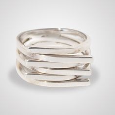 Stylish and eye catching line  design ring, handcrafted in Mexico. This bestseller ring is very eye catching when worn due to the multiple areas it catches the light. Modern Silver Stackable Wide Band Ring, Modern Sterling Silver Wide Band Ring With Open Band, Modern Sterling Silver Wide Band Ring With Open Design, Modern Sterling Silver Wide Band Ring With Open Shape, Modern Wide Band Stackable Sterling Silver Rings, Modern Jewelry With Unique Spiral Design, Modern Sterling Silver Midi Rings With Open Band, Modern Sterling Silver Open Band Midi Rings, Silver Ring With A Modern Twist And Unique Design