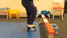 a young boy balances on a trampoline