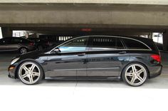 a car parked in a parking garage next to another car