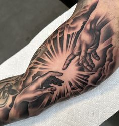 a man with a tattoo on his arm holding the hands of another person