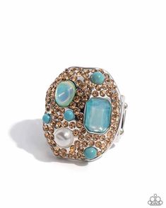 Embellished in light-colored topaz rhinestones, an oval abstract silver ring glitters atop the finger. Turquoise beads, a white pearl, an emerald-cut aquamarine gem, and an aquamarine iridescent oval bead create additional color and shine. Features a stretchy band for a flexible fit. Due to its prismatic palette, color may vary.   Sold as one individual ring. Aquamarine Gem, Pink Iridescent, Kids Bracelets, Palette Color, Paparazzi Accessories, Anklet Bracelet, May 2024, Paparazzi Jewelry, White Earrings