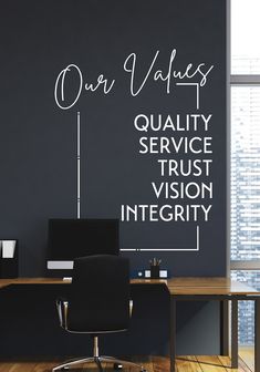 an office with black walls and white writing on the wall that says our value quality, service, trust, vision, integity