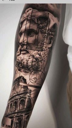 a man's arm with tattoos on it and an image of a building in the background