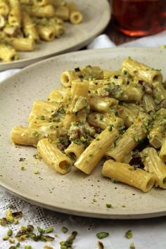 a white plate topped with pasta covered in sauce