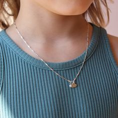 This personalized Tiny Token piece features a delicate heart that's hand-stamped with an initial. Gently hanging from a sturdy bar-link chain, this necklace is the embodiment of sweet elegance. A 1.5” extender chain for the clasp ensures that the necklace can grow with your child. DETAILS14k gold fill or sterling silverSize 12-13.5” fits most children ages 2-5Size 14-15.5” fits most children ages 5-10.Hypoallergenic, Nickel Free and Water Safe Dainty Adjustable Charm Necklace With Heart Charm, Dainty Heart Pendant Name Necklace For Everyday, Dainty Everyday Name Necklace With Heart Pendant, Sterling Silver Charm Necklace With Delicate Chain For Birthday, Dainty Heart Pendant Charm Necklace For Birthday, Dainty Heart Pendant Name Necklace With Charm, Dainty Name Necklace With Heart Pendant, Dainty Heart Pendant Name Necklace, Dainty Name Necklace With Heart Charm