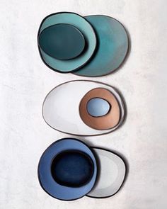 three plates with different colors and shapes on them