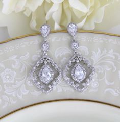 "Vintage style dangle earrings have the drama of 1920's platinum and diamond jewelry. At 1 3/4\" h x 3/4\" w, these beautiful bridal earrings are a must-have for the bride seeking a one-of-a-kind design for her wedding day! With silver pave scrolls and micro pave dangles, these CZ earrings have the elegance of genuine vintage heirlooms. Matching necklace; https://www.etsy.com/listing/261838550/art-deco-necklace-crystal-wedding" Classic Chandelier Earrings With Elegant Design, Classic Chandelier Drop Earrings With Elegant Design, Classic Drop Chandelier Earrings For Wedding, Elegant Chandelier Drop Earrings For Anniversary, Ornate Wedding Diamond Drop Earrings, Classic Cubic Zirconia Chandelier Earrings For Wedding, Classic Chandelier Dangle Earrings For Wedding, Classic Chandelier Earrings With Intricate Design For Anniversary, Ornate Dangle Bridal Earrings For Anniversary