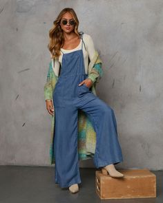 Meet the Nolah Relaxed Chambray Overall Jumpsuit—your go-to for effortlessly chic autumn style. Crafted from lightweight chambray fabric, this jumpsuit effortlessly blends Western ruggedness with Bohemian ease. Features include a practical front chest pocket and side slant pockets, plus adjustable shoulder ties for a perfect fit. Whether exploring fall foliage or lounging around, this jumpsuit offers a relaxed yet refined look that captures the essence of the season. Lightweight chambray fabric Medium Wash Overalls For Day Out, Bohemian Jumpsuits And Rompers With Pockets For Spring, Light Wash Relaxed Denim Jumpsuit For Day Out, Spring Cotton Medium Wash Jumpsuits And Rompers, Spring Medium Wash Cotton Jumpsuits And Rompers, Chic Light Wash Cotton Jumpsuits And Rompers, Spring Cotton Jumpsuits And Rompers In Medium Wash, Bohemian Overalls With Pockets For Spring, Light Wash Denim Overall Jumpsuit For Day Out