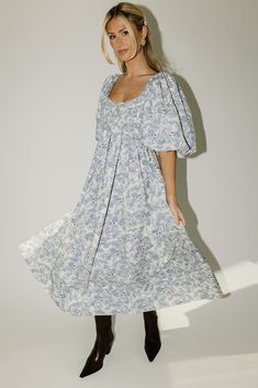 the search for the perfect all-season wedding guest dress is over. this stunning puff sleeve midi dress features a blue floral pattern + a flirty corset-inspired bodice. guaranteed to turn heads with every wear, it’s a must-have for cocktail parties, holiday dinners, or anytime you feel like frolicking. blue floral // midi length, scoop neckline, dramatic puff sleeves, back zipper closure, smocked bodice, fully lined model is 5'8" + wearing a small measurements are approximate + taken while layi Floral Print Puff Sleeve Midi Dress, Floral Print Midi Puff Sleeve Dress For Garden Party, Puff Sleeve Midi Dress With Floral Print For Brunch, Brunch Floral Print Midi Dress With Puff Sleeves, Puff Sleeve Floral Midi Dress For Brunch, Garden Party Floral Print Midi Puff Sleeve Dress, Blue Floral Print Puff Sleeve Midi Dress, Blue Floral Print Midi Length Puff Sleeve Dress, Blue Floral Print Midi Dress With Puff Sleeves