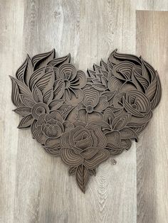 an intricately carved wooden heart on the floor