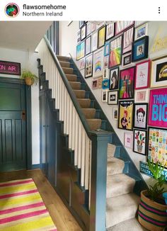 a staircase with pictures on the wall next to it