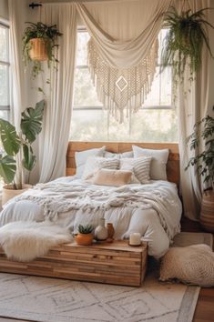 a large bed sitting in a bedroom next to a window with plants on the windowsill