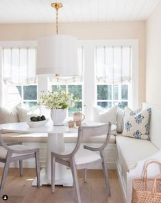 a dining room table with chairs and a bench