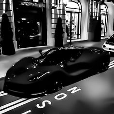 a black and white photo of a sports car