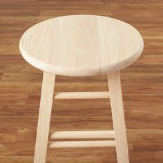 a wooden stool sitting on top of a hard wood floor