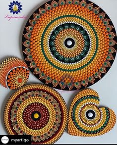 three circular designs made out of beads on a white surface