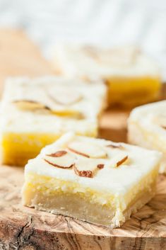 several pieces of cake sitting on top of a wooden cutting board next to each other