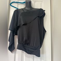 Elevate Your Wardrobe With This Stunning Ramy Brook North One Shoulder Top. This Black, Solid Patterned Top Features A Ruffle Accent, Flutter Sleeves, And A One-Shoulder Strap Type. The Pullover Closure Makes It Easy To Wear, And It Is Perfect For Both Casual And Party/Cocktail Occasions. Crafted From 100% Polyester Fabric, This Top Is Breathable And Perfect For The Summer, Fall, And Spring Seasons. It Is A Regular Fit, Size L, And Has No Personalization Or Vintage Features. The Garment Care Ins Black One-shoulder Top For Work, Black One Shoulder Top With Asymmetrical Hem For Party, Black Long Sleeve One Shoulder Top For Night Out, Elegant Black One Shoulder Top With Asymmetrical Hem, Elegant Black One-shoulder Top With Asymmetrical Hem, One-shoulder Black Top For Fall, Fall Black One Shoulder Top, Fall One-shoulder Black Top, Black Blouse With Asymmetrical Neckline For Evening