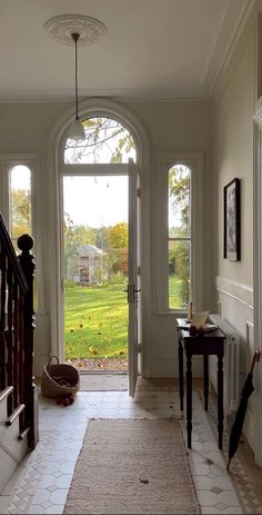 an entry way leading to a large open door with a view of a grassy field