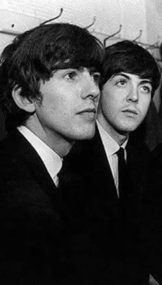 the beatles are sitting next to each other