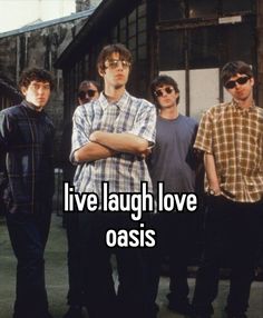 four men standing next to each other with the words live laugh love oasis