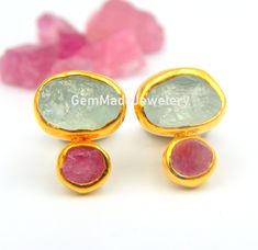 "Aquamarine and Pink Tourmaline Raw Gemstone Stud Earrings made out of 18 karat Gold plated Sterling Silver. 100% Handmade Jewellery. AQUAMARINE: Aquamarine, the birthstone of March, has a rich color and has long been a symbol of youth, health and hope. Its mesmerizing color ranges from pale to deep blue and are reminiscent of the sea. A perfect birthstone for March, the Aquamarine creates a beautiful accent to spring and summer wardrobes. TOURMALINE: Tourmaline is the newer October birthstone. Tourmaline Multi-stone Earrings For Gift, Tourmaline Multi-stone Earrings As Gift, Round Tourmaline Gemstone Earrings, Multi-stone Tourmaline Earrings As A Gift, Chrome Tourmaline, Peridot Pendant, Tourmaline Earrings, Aquamarine Earrings, Gemstone Stud Earrings