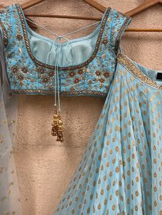 A three-piece powder blue sharmily zari lehenga set from the Priti Sahni collection. This georgette powder blue butti lehenga with pearl-zari work border detail is paired with a powder blue blouse in raw silk fabric with sequin and zardozi hand embroidery. This outfit is completed with a powder blue tulle dupatta in net material with sequin work. Zari Lehenga, Lehenga Color Combinations, Designer Lehnga Choli, Raw Silk Blouse, Anarkali Dresses, Powder Blue Color, Georgette Lehenga, Pearl Work, Lehnga Dress