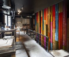 a restaurant with colorful striped walls and wooden tables