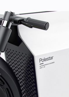 closeup of the headphones on top of an electric scooter that is white and black