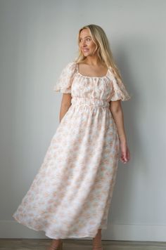 Expertly crafted for style and comfort, our Blossom Floral Print Midi Dress in Peachy is perfect for any occasion. Featuring charming puff sleeves, a flattering elastic waist, and convenient pockets, this dress effortlessly combines classic elegance with modern functionality. The square neck adds a touch of sophistication, making it a must-have for any wardrobe. square neckline puff sleeves elastic waist lined 100% polyester true to size model is wearing a medium Aesthetic Comfy Outfits, Modesty Journey, Bump Friendly Dress, Curvy Date Night Outfit, Air Clothes, Church Outfit, Cozy Fall Outfits, Valentines Day Dresses, Banquet Dresses