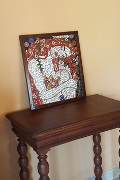 a wooden table with a painting on top of it