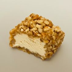 a piece of cake with nuts on it sitting on top of a white countertop