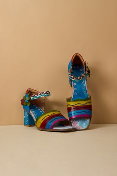 Take a bold step into adventure with our Soffia rainbow pump heels, featuring a vibrant rainbow stripe leather upper pattern. Elevate your style and make a statement with these daring and romantic heels. Show off your fearless attitude and rock these shades of striped pumps with confidence and romance! 2.56" heel Snap clasp closure Genuine leather upper Leather footbed Leather lining Leather midsole Rubber sole Multicolor High Heels With Stacked Heel, Multicolor Stacked High Heels, Bold Multicolor Ankle Strap Heels, Multicolor 4-inch Heel Closed Toe Heels, Multicolor Closed Toe Heels With 4-inch Heel, Multicolor Open Toe Heels With Padded Heel, Multicolor Heels With Ankle Strap And Heel Strap, Multicolor Heels With Ankle And Heel Strap, Bold Multicolor Open Heel Heels