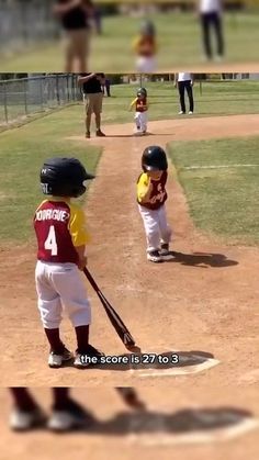 two young boys playing baseball on a field