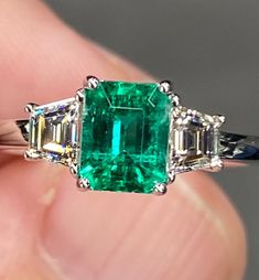 ALL THESE PHOTOS WERE TAKEN WITH AN ORDINARY IPHONE & HAVE NOT BEEN EDITED OR ENHANCED IN ANY WAY. VIDEO LINKS: https://youtube.com/shorts/91DOEQGWjzk?feature=share https://youtube.com/shorts/z3jiQSNa_IY?feature=share Up For Sale is Super Fine Natural Colombian Emerald & Diamond Ring in Solid 18K White Gold. This Ring was made by us Here in New York City & is of the Highest Quality. The Center Stone is a Fantastic Natural 1 Ct Vivid Green Emerald that measures Approx 6.4 x 5.1 mm, was Mined in C Luxury Multi-stone Emerald Diamond Ring, Luxury Multi-stone Exquisite Emerald Ring, Luxury Silver Emerald Ring With Rectangular Stone, Luxury Multi-stone Emerald Ring In Sterling Silver, Luxury Silver Emerald Ring With Tension Setting, Luxury Emerald Ring In Diamond White, Luxury Green Emerald Ring In Sterling Silver, Luxury Sterling Silver Emerald Ring With Vvs Clarity, Luxury Silver Emerald Ring With Three Stones