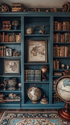 a bookshelf filled with lots of books next to a rug and wall mounted globe