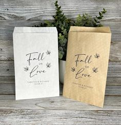 two brown and white paper bags sitting next to each other