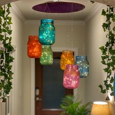 colorful mason jars are hanging from the ceiling