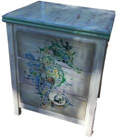 an ornate painted wooden cabinet with drawers