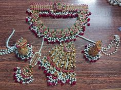 an assortment of jewelry on a wooden table