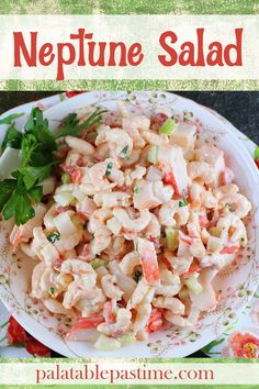 a white plate topped with pasta salad next to a green and red flowered napkin