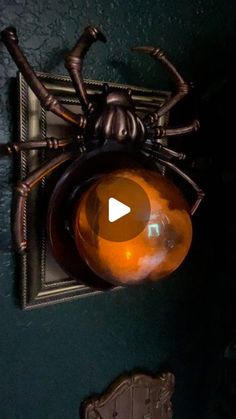 a spider lamp hanging from the side of a wall