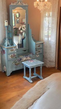 a bedroom with a blue dresser and mirror