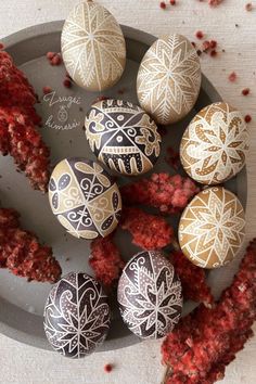 an assortment of decorated eggs on a plate