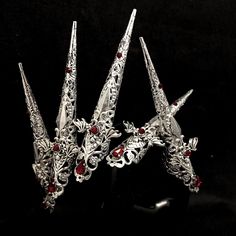 Bloodlust nail rings  Set of 5 Beautiful long nail claws, decorated with bat  wing daggers and adorned with blood red rhinestones. Rings are adjustable. Rhinestone colour can be changed, silver is shown here. Handmade to order.  Takes 2 weeks but may take longer during busy times.  Do not submerge in water or intense heat or flame Perfect addition to our Bloodlust  collection. ------------------------------------------------------------------------------------------------------------------------ Vampire Claws, Nail Claws, Alternative Accessories, Nail Rings, Rings Gothic, Gothic Jewellery, Goth Nails, Black Nail Polish, Long Nail