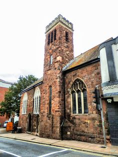 an old brick church with a clock tower