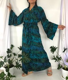 Bali hand stamped Batik Robes in Black Greenery print perfect for cover up. The bathrobe has 2 pockets and inner strings that can be tied. A wide Obi sash belt is included in the matching print.  A long bell sleeve give an elegant look.  100% Rayon  The model is 167 cm in height and 54 kgs, if you need to adjust the length and sleeve length please don't hesitate to ask me.  The size is one size fits for all sizes If you need more detail information about this products, Custom Order and for WHOLESALE enquiry please don't hesitate to message me :) Long Sleeve Batik Print Kaftan For Festivals, Bohemian Batik Print Patterned Kimono, Long Sleeve Batik Print Kaftan For Vacation, Core Wardrobe Pieces, Long Kimono Jacket, Obi Sash, Women Kimono, Plus Size Kimono, Outer Jacket