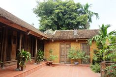 an outdoor courtyard with potted plants and trees