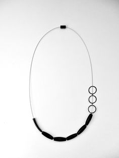 Silver Necklace - A study of balance and asymmetry, this unique necklace arranges blackstone beads, sterling silver elements, and rubber on a stainless steel cable. Modern Onyx Jewelry With Black Beads, Modern Black Jewelry, Everyday Black Single Strand Necklace, Modern Black Sterling Silver Necklace, Contemporary Adjustable Black Jewelry, Modern Black Onyx Necklace, Rubber Necklace, Stainless Steel Cable, Artful Home